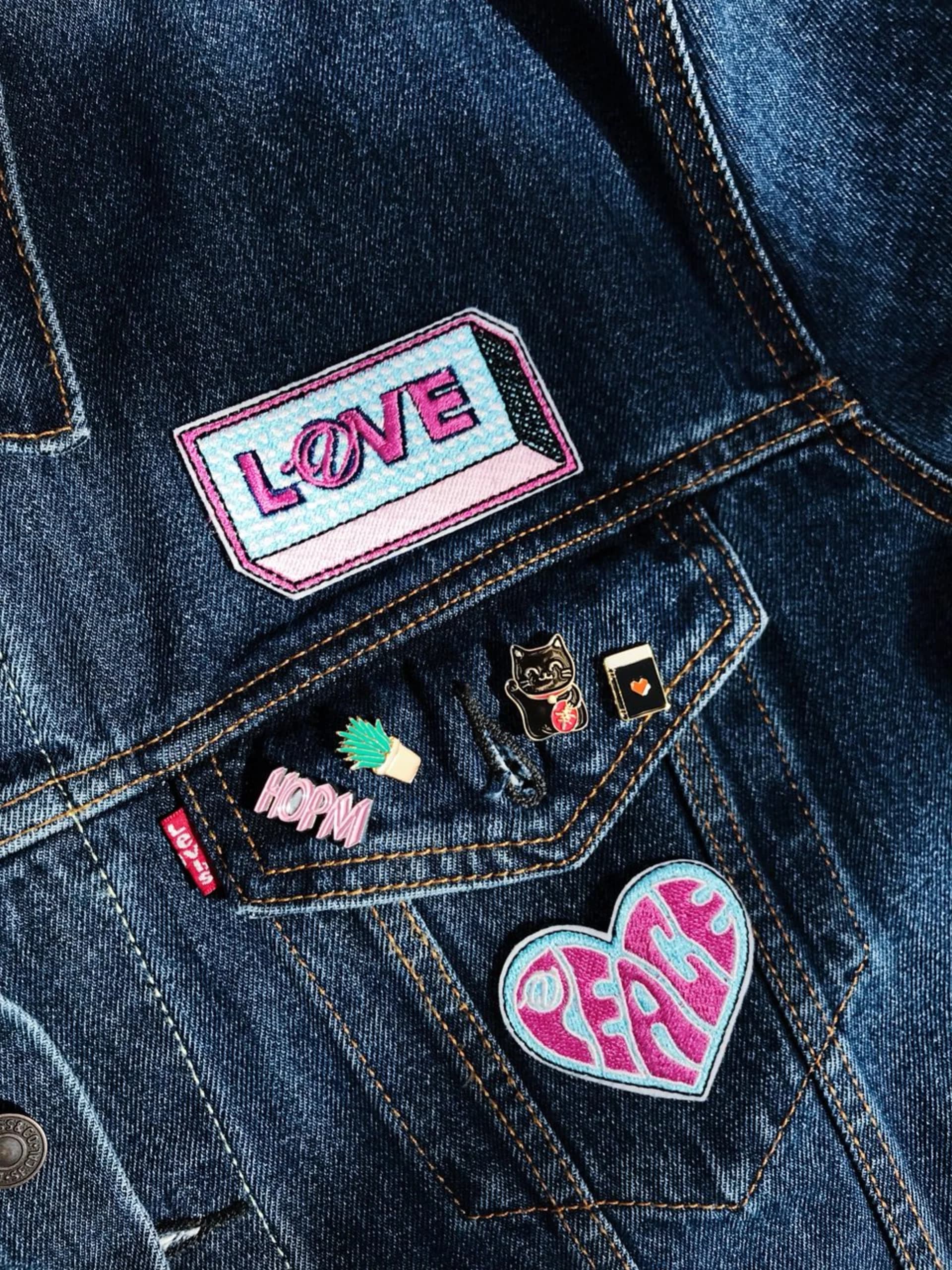 Close-up of LOVE and PEACE patches on denim