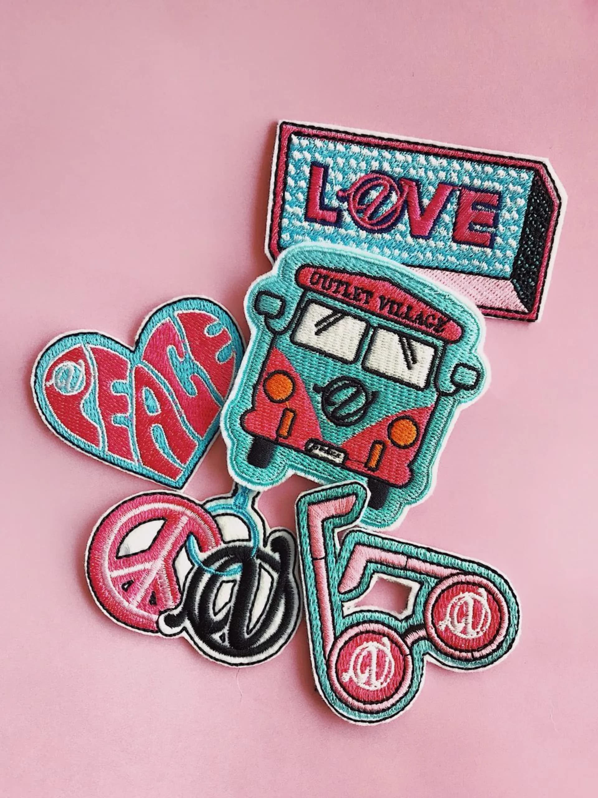 Embroidered patches on pink background